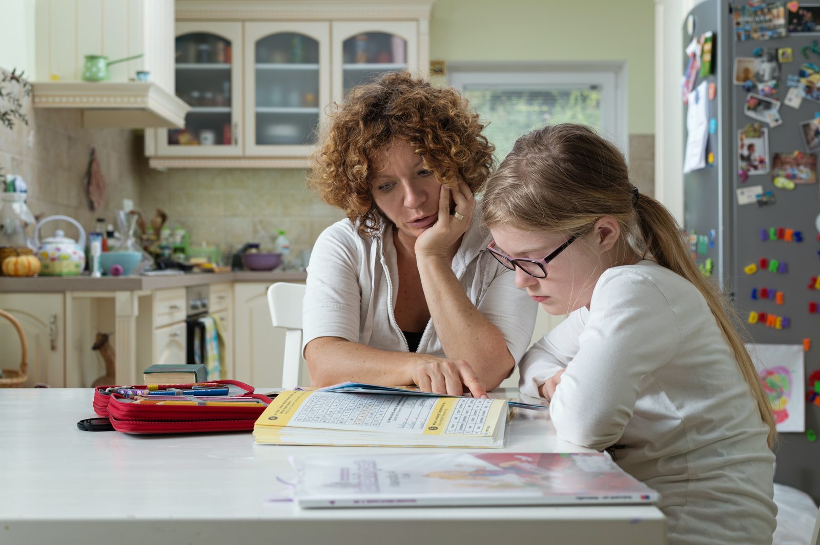 A parent helping a student with schoolwork